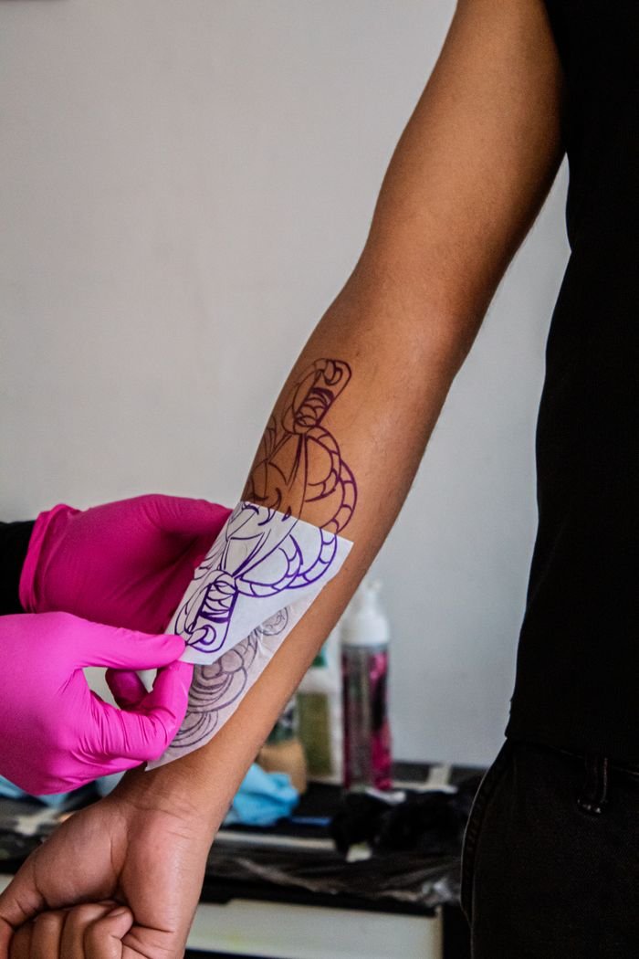 Stencil being applied to a client's arm