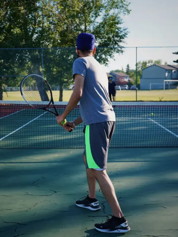 Coach Arjun Patel playing a forehand