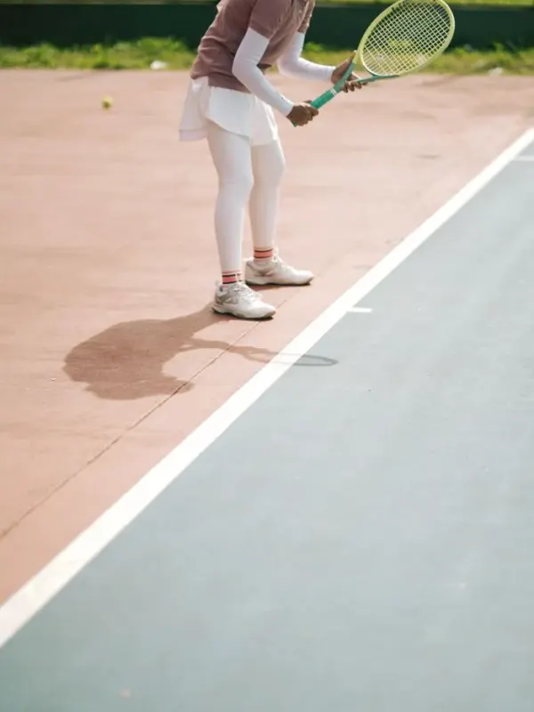 Coach Maya Collins preparing to serve