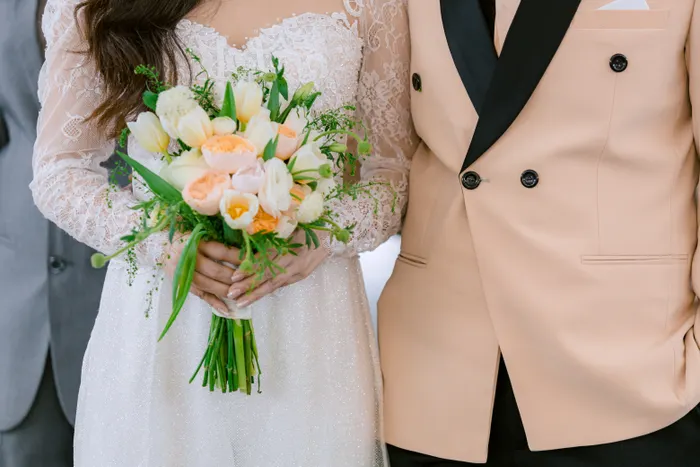 Couple holding a floral bouquet