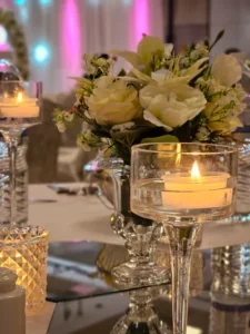 Floral centerpiece with candles on a wedding table