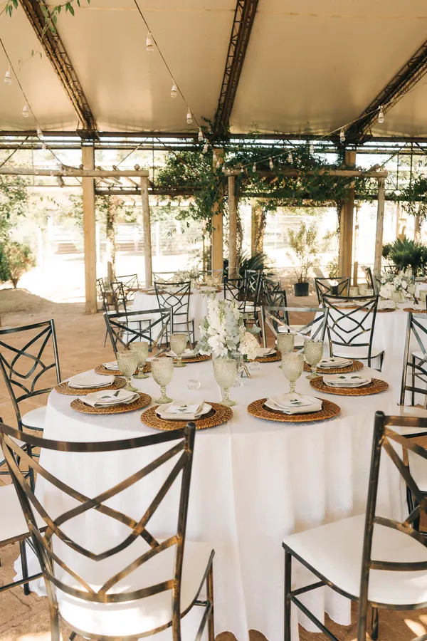 Reception tables under an outdoor canopy