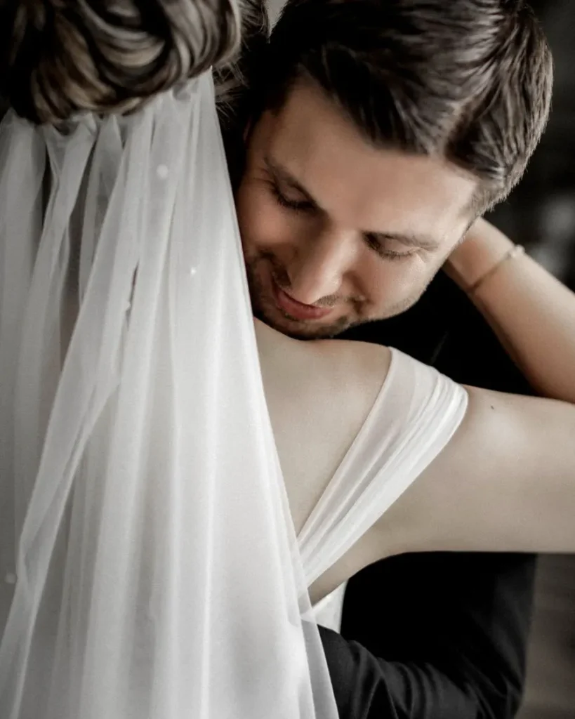 Close portrait of a bride and groom embracing