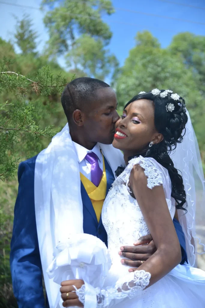 Groom kissing the bride outdoors
