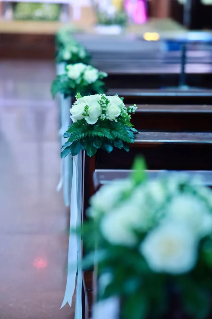 Church aisle lined with white roses