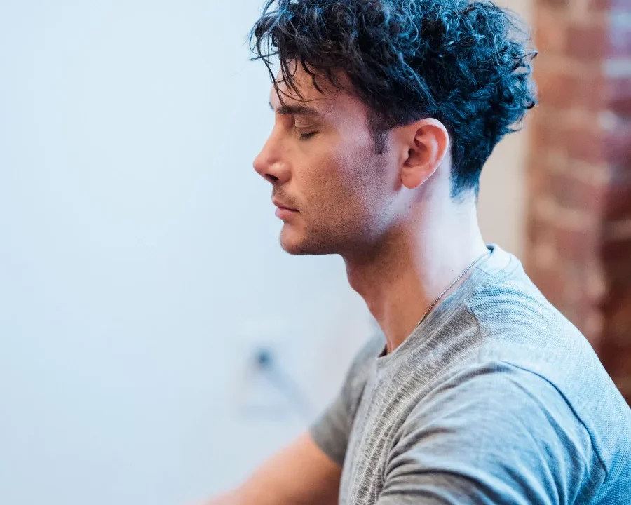 Man meditating with his eyes closed