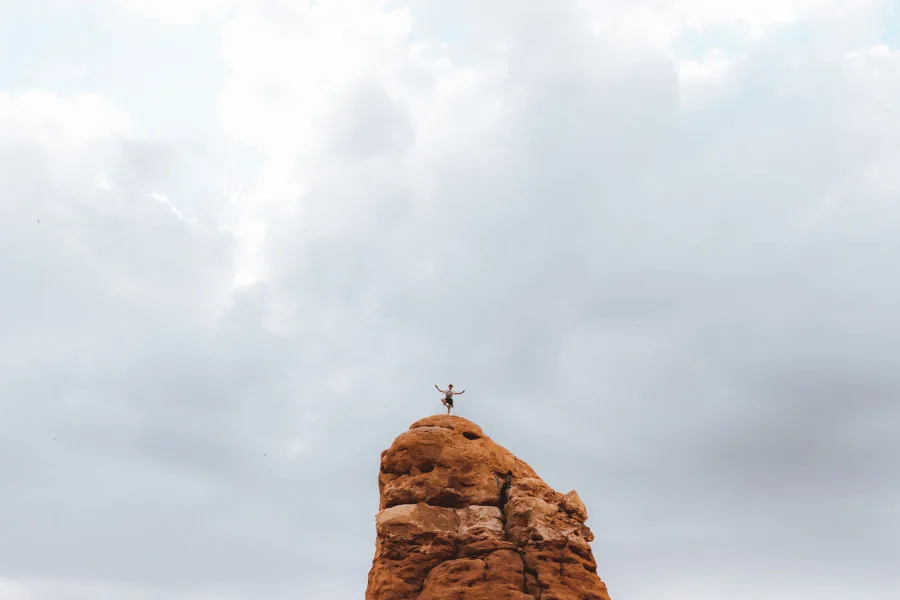 Person balancing on top of a rock formation