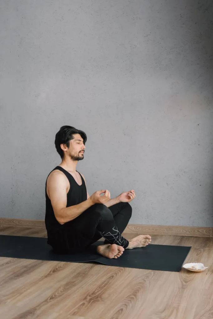 Man meditating on a yoga mat